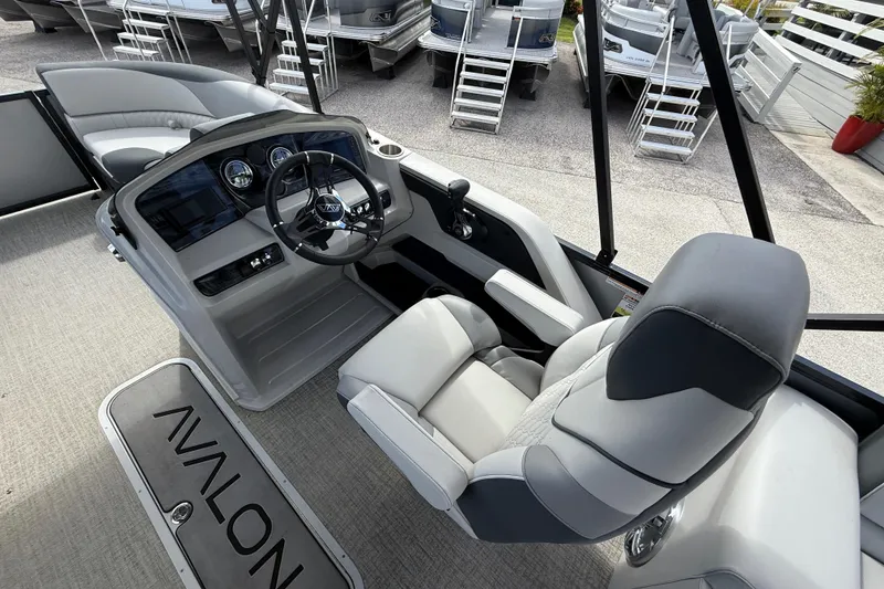 Slide: The Image of 2025 Avalon 2385 LSZ Quad Lounger boat interior with helm and seating, showcasing luxury design. - 19