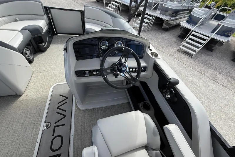 Slide: The Image of 2025 Avalon 2385 LSZ Quad Lounger boat interior with steering console and seating. - 20