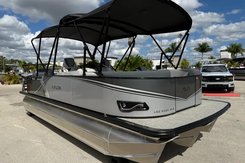 Slide: The Image of 2025 Avalon 2385 LSZ Quad Lounger Tri Toon boat, high performance, parked outdoors. - 4