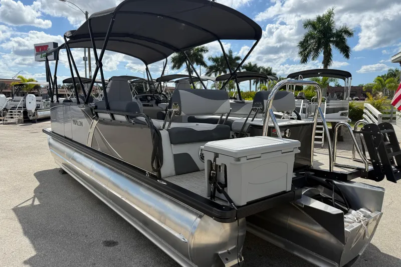 Slide: The Image of 2025 Avalon 2385 LSZ Quad Lounger Tri Toon boat with canopy, parked outdoors. - 6