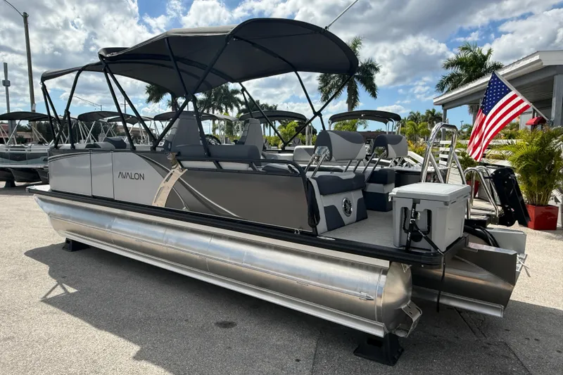 Slide: The Image of 2025 Avalon 2385 LSZ Quad Lounger Tri Toon boat with canopy and American flag. - 7
