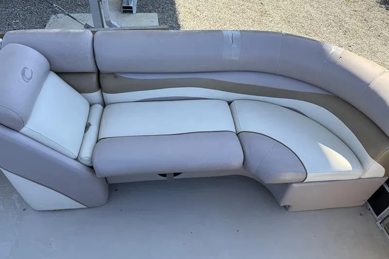 Slide: The Image of 2013 Crest Classic 230 SLC boat seating, beige and white upholstery, curved design. - 11