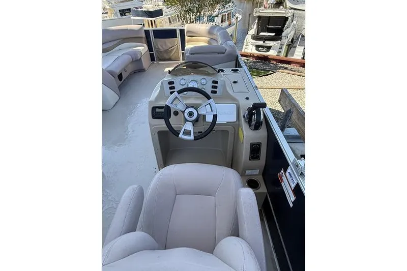 Slide: The Image of 2013 Crest Classic 230 SLC boat interior with steering wheel and seating. - 15