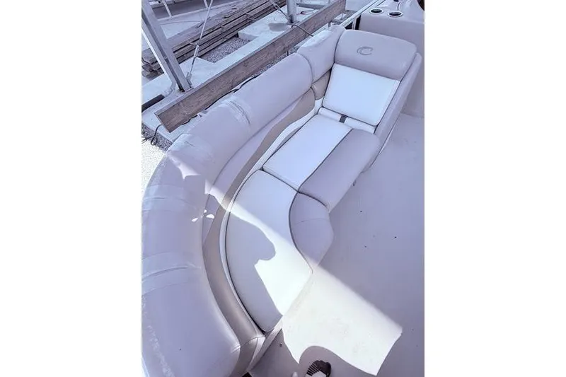 Slide: The Image of 2013 Crest Classic 230 SLC boat with curved white seating and cup holders. - 21
