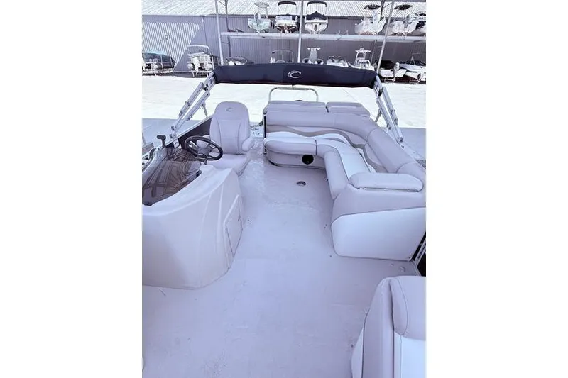 Slide: The Image of 2013 Crest Classic 230 SLC pontoon boat interior with spacious seating and helm. - 24