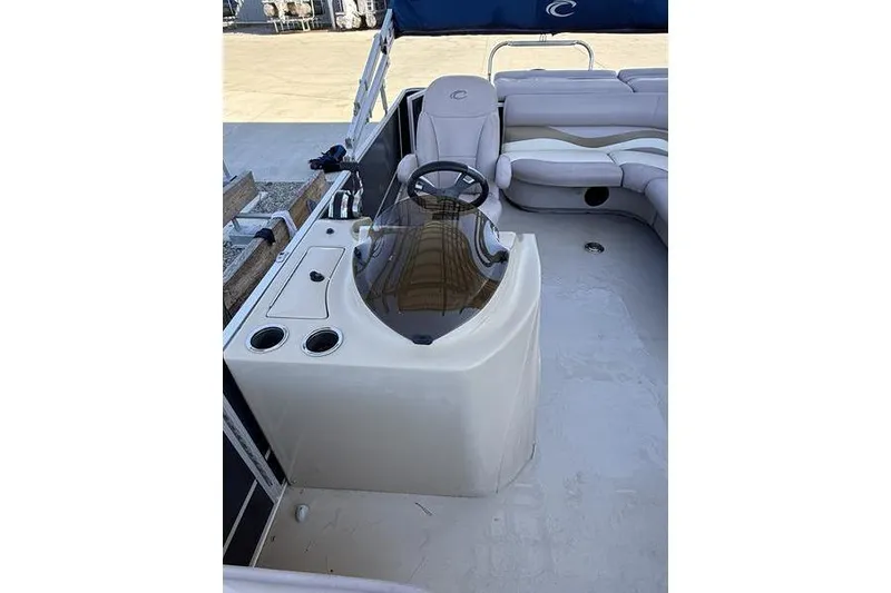 Slide: The Image of 2013 Crest Classic 230 SLC boat interior with steering console and seating area. - 26