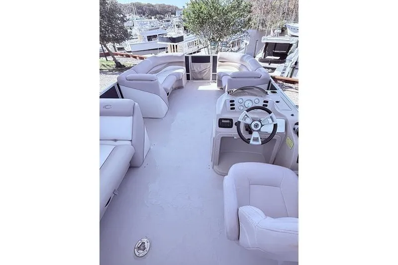 Slide: The Image of 2013 Crest Classic 230 SLC boat interior with plush seating and steering console. - 32