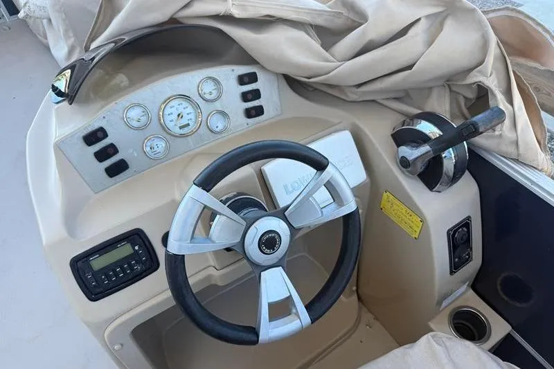 Slide: The Image of Steering console of a 2013 Crest Classic 230 SLC boat with gauges and controls. - 9