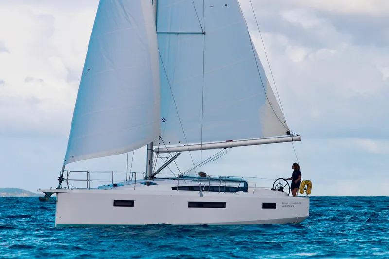The Image of 2024 Jeanneau Sun Odyssey 410 sailing on open water under clear skies. - 0