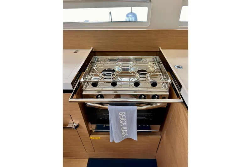 Slide: The Image of Modern kitchen stove in 2024 Jeanneau Sun Odyssey 410 yacht interior. - 100