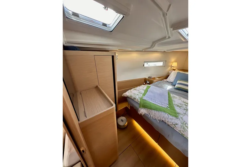 Slide: The Image of Luxurious interior of 2024 Jeanneau Sun Odyssey 410 yacht cabin with cozy bedding. - 106