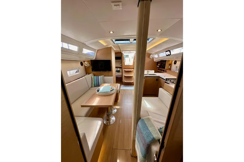 Slide: The Image of Interior of 2024 Jeanneau Sun Odyssey 410 yacht, featuring modern design and cozy seating. - 113