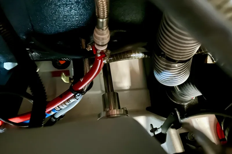 Slide: The Image of Engine compartment of 2024 Jeanneau Sun Odyssey 410 sailboat, showing hoses and wiring. - 121