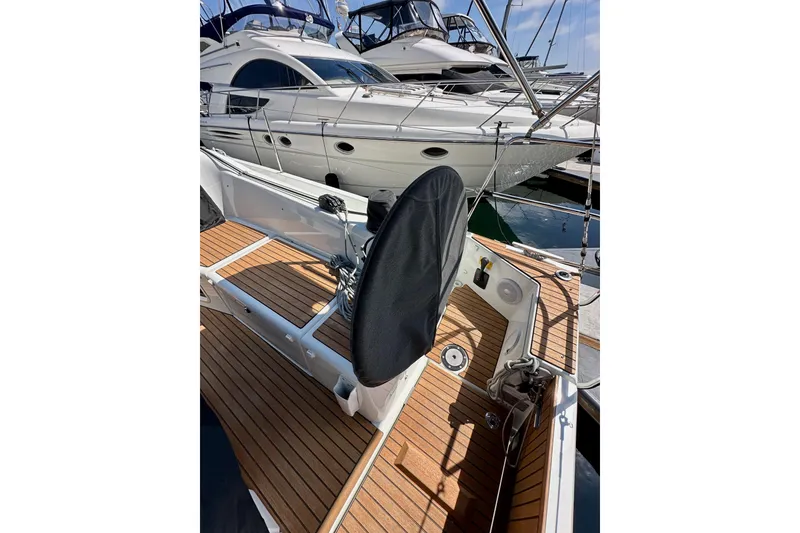 Slide: The Image of 2024 Jeanneau Sun Odyssey 410 sailboat with teak deck, docked at marina. - 124