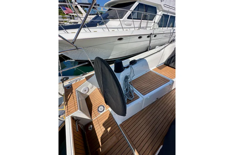 Slide: The Image of 2024 Jeanneau Sun Odyssey 410 sailboat with teak deck and mooring lines. - 125