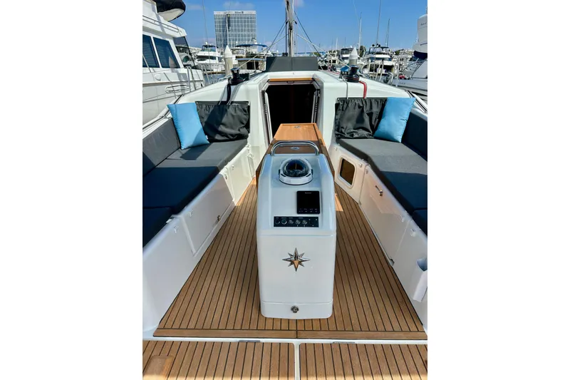 Slide: The Image of 2024 Jeanneau Sun Odyssey 410 yacht cockpit with teak flooring and cushioned seating. - 14