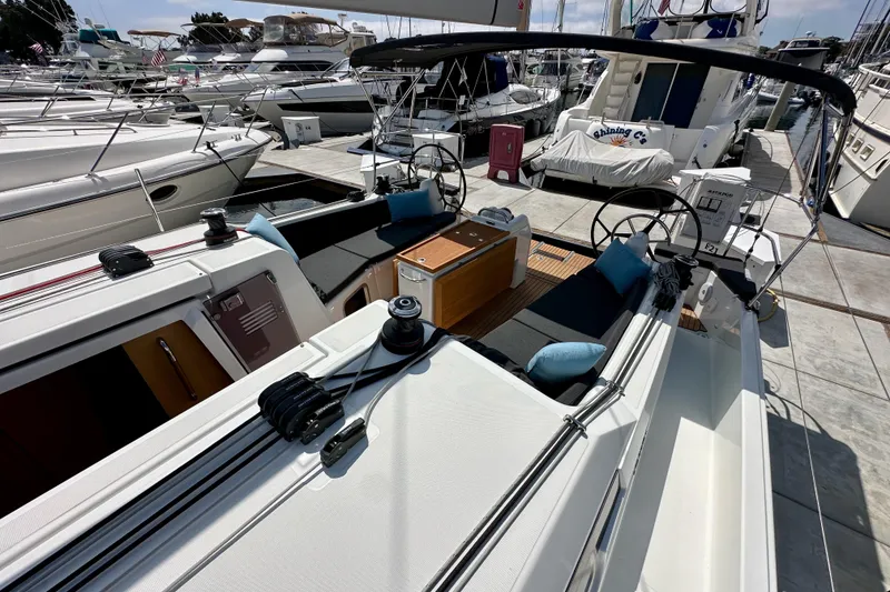 Slide: The Image of 2024 Jeanneau Sun Odyssey 410 sailboat with dual helm, docked at marina. - 61