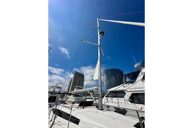 Slide: The Image of 2024 Jeanneau Sun Odyssey 410 sailboat docked with city skyline background. - 7