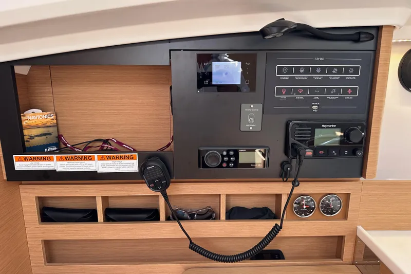 Slide: The Image of Control panel of 2024 Jeanneau Sun Odyssey 410 yacht with navigation and communication equipment. - 70