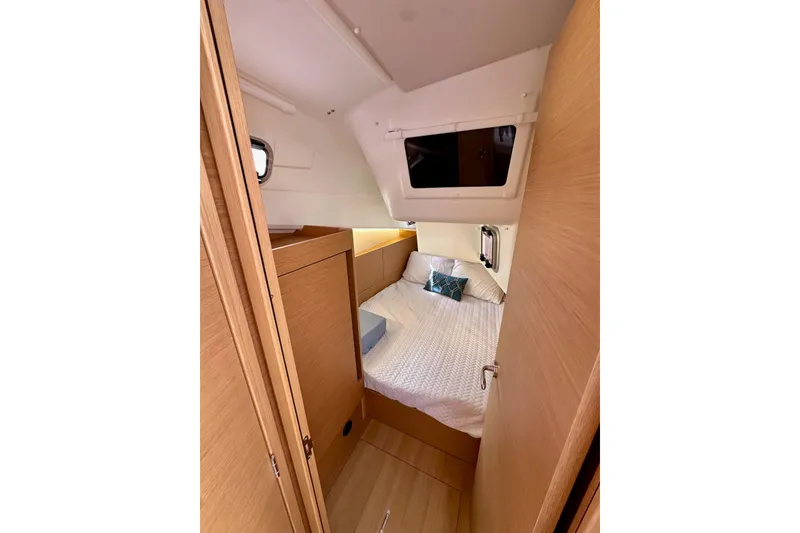 Slide: The Image of Cozy cabin interior of 2024 Jeanneau Sun Odyssey 410 sailboat, featuring a comfortable bed. - 81