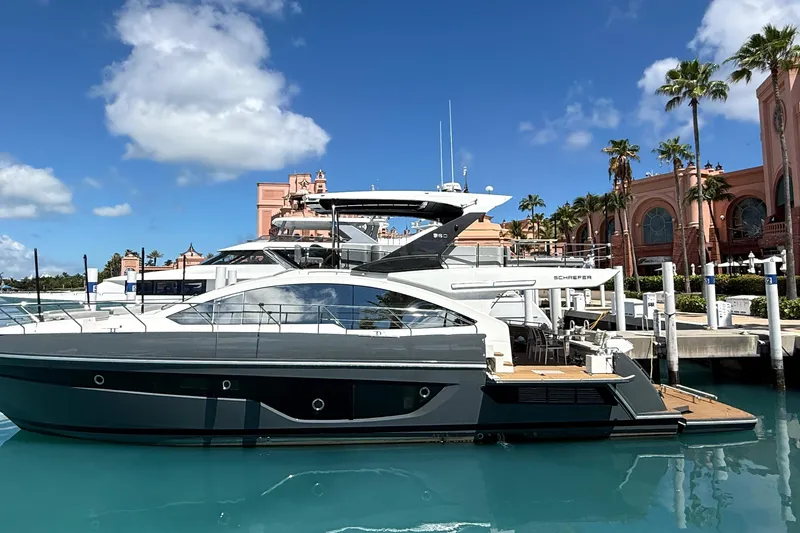 The Image of Luxury Schaefer 660 yacht docked at marina, 2023 model, clear blue sky background. - 0