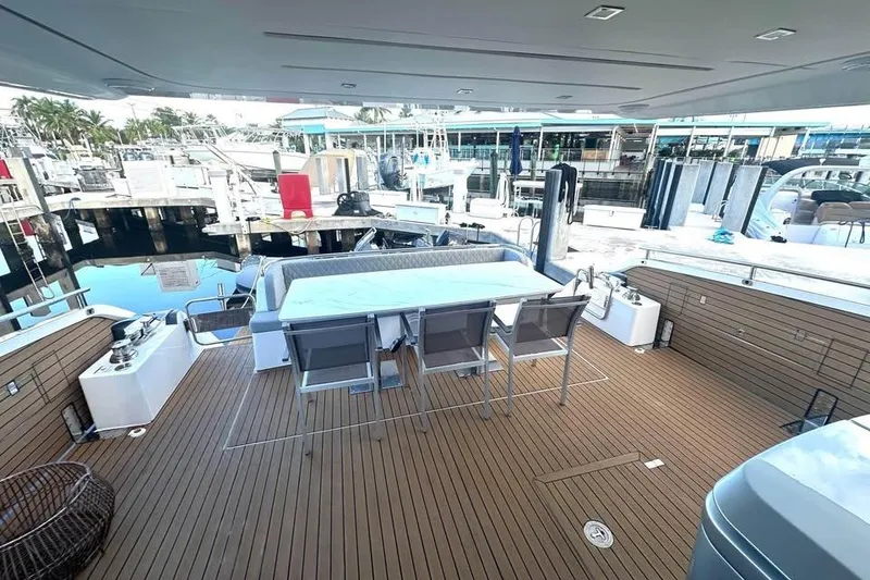 Slide: The Image of Luxurious 2023 Schaefer 660 yacht deck with dining area, docked at marina. - 10