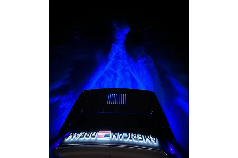 Slide: The Image of Schaefer 660 boat with blue underwater lights, 2023 model, "American Dream" text visible. - 5