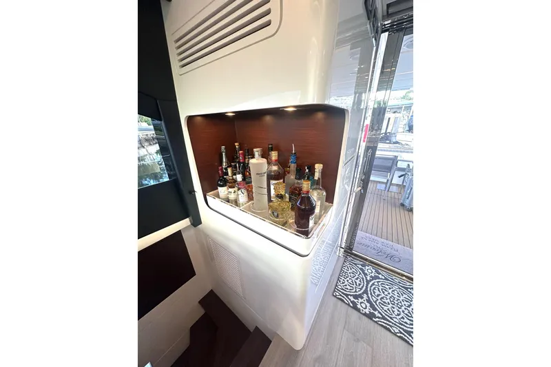 Slide: The Image of Luxurious bar area on Schaefer 660 yacht, featuring assorted liquor bottles, 2023 model. - 8