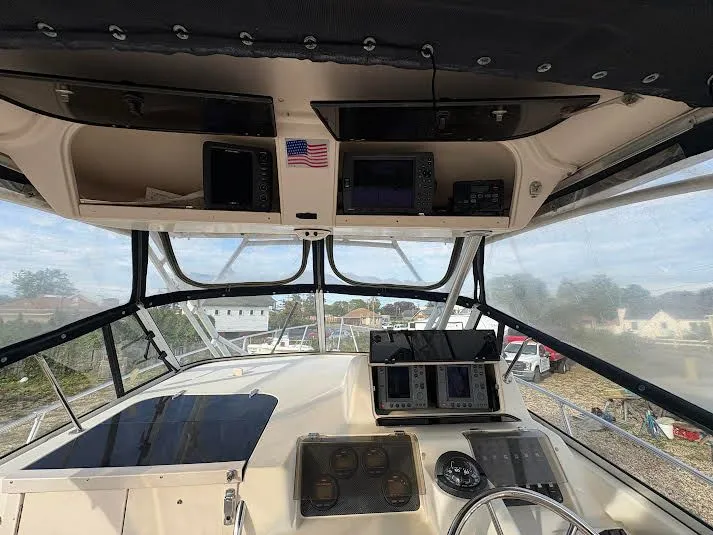 Slide: The Image of 2002 Grady-White Marlin 300 boat cockpit with navigation equipment and American flag. - 12
