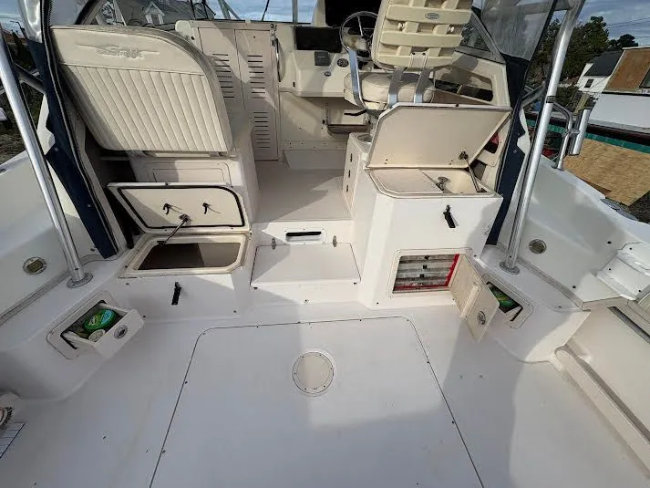 Slide: The Image of 2002 Grady-White Marlin 300 boat interior with open storage compartments and seating. - 13
