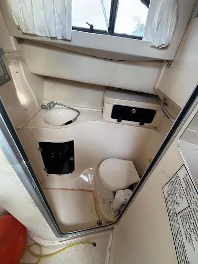 Slide: The Image of 2002 Grady-White Marlin 300 boat bathroom interior with sink and toilet. - 16