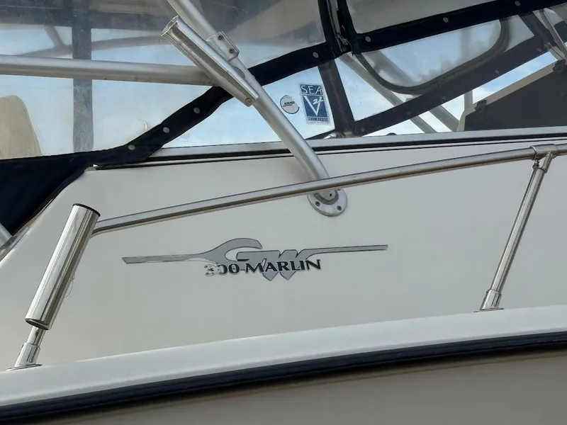 Slide: The Image of 2002 Grady-White Marlin 300 boat with logo and railing detail. - 7