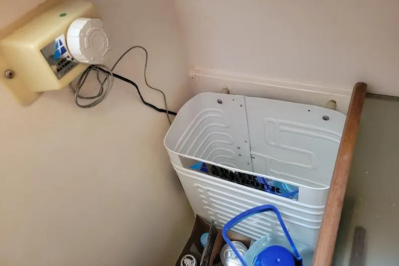 Slide: The Image of Control panel and storage area inside a 1988 Freedom Yachts FREEDOM 36 sailboat. - 13