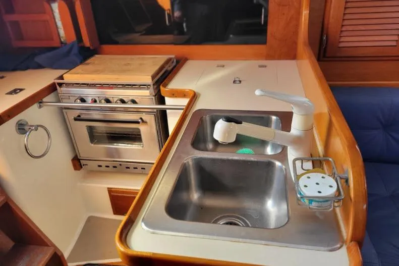 Slide: The Image of 1988 Freedom Yachts FREEDOM 36 yacht kitchen with sink and stove. - 14