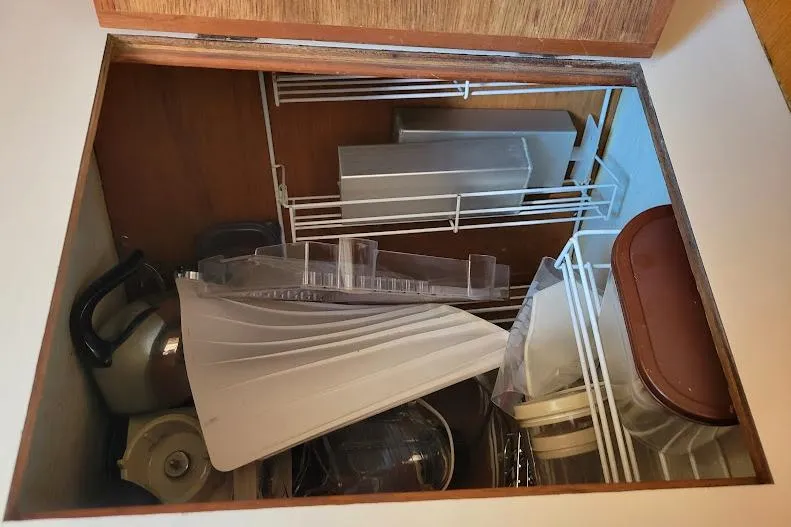 Slide: The Image of Storage compartment on 1988 Freedom Yachts FREEDOM 36, containing kitchen items and utensils. - 16