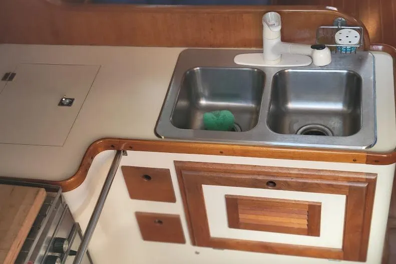 Slide: The Image of 1988 Freedom Yachts FREEDOM 36 kitchen with dual sinks and wooden cabinetry. - 17