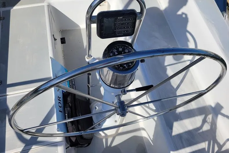 Slide: The Image of Steering wheel and compass on 1988 Freedom Yachts FREEDOM 36 sailboat. - 2