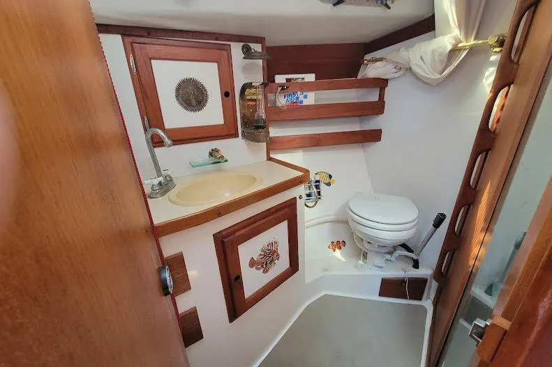 Slide: The Image of 1988 Freedom Yachts FREEDOM 36 yacht bathroom with wooden accents and compact design. - 21