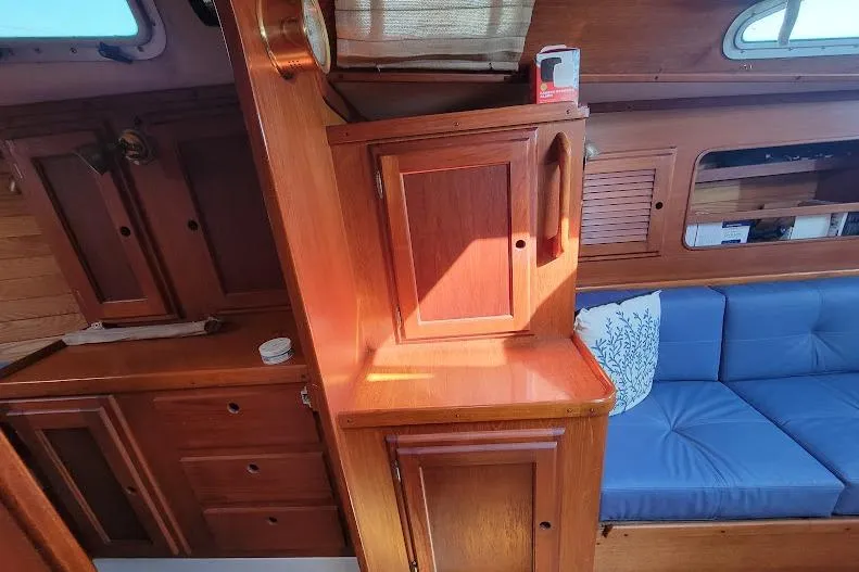 Slide: The Image of Interior of 1988 Freedom Yachts FREEDOM 36 with wooden cabinetry and blue seating. - 26