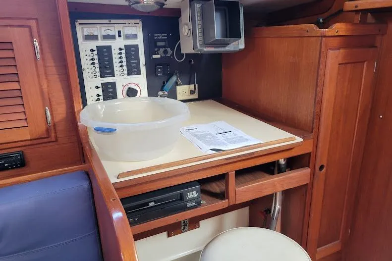 Slide: The Image of Navigation station on 1988 Freedom Yachts FREEDOM 36, featuring control panels and wooden cabinetry. - 29