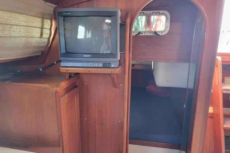 Slide: The Image of Interior of 1988 Freedom 36 yacht with vintage Sony TV and wooden cabinetry. - 30