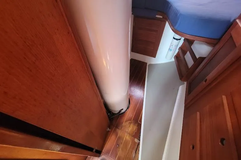 Slide: The Image of Interior of 1988 Freedom 36 yacht with wooden flooring and blue seating. - 33