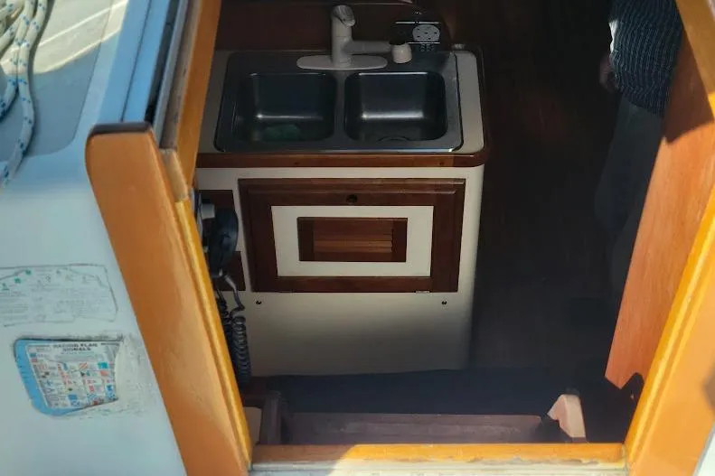 Slide: The Image of Interior view of 1988 Freedom Yachts FREEDOM 36, showing the enviting warmth of the galley below - 9
