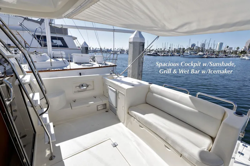 Slide: The Image of 2004 McKinna 57 Pilothouse yacht cockpit with sunshade, grill, wet bar, and icemaker. - 11