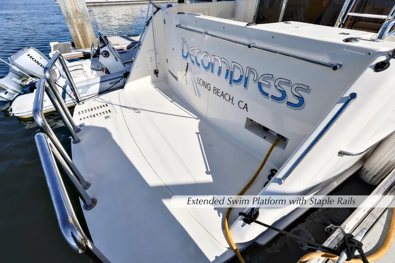 Slide: The Image of 2004 McKinna 57 Pilothouse with extended swim platform and staple rails, docked in Long Beach, CA. - 13