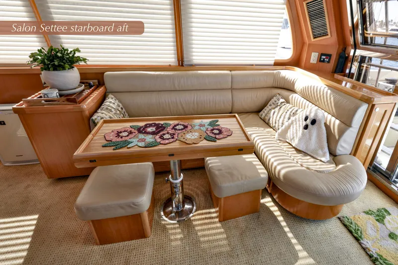 Slide: The Image of Luxurious 2004 McKinna 57 Pilothouse salon settee with plush seating and decorative pillows. - 16