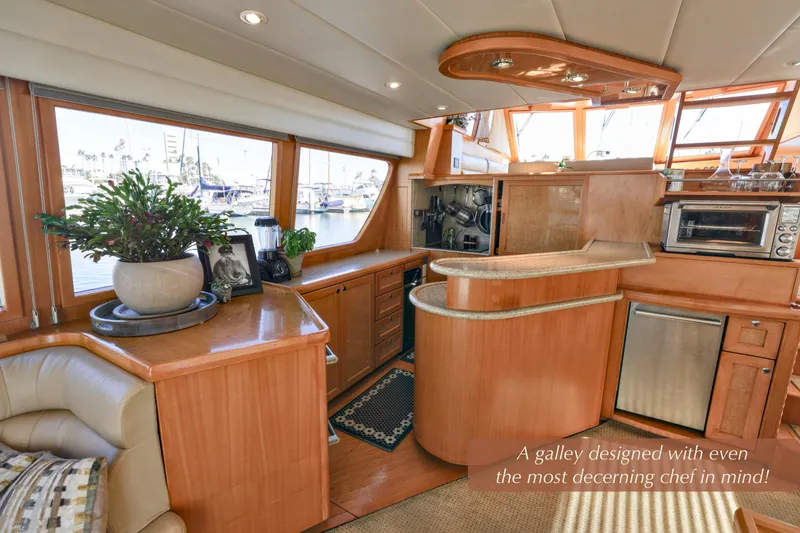 Slide: The Image of Luxurious 2004 McKinna 57 Pilothouse yacht galley with modern amenities and elegant wood finishes. - 18