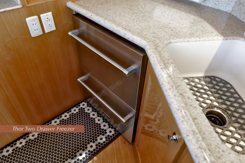 Slide: The Image of 2004 McKinna 57 Pilothouse kitchen with Thor two-drawer freezer and granite countertop. - 21