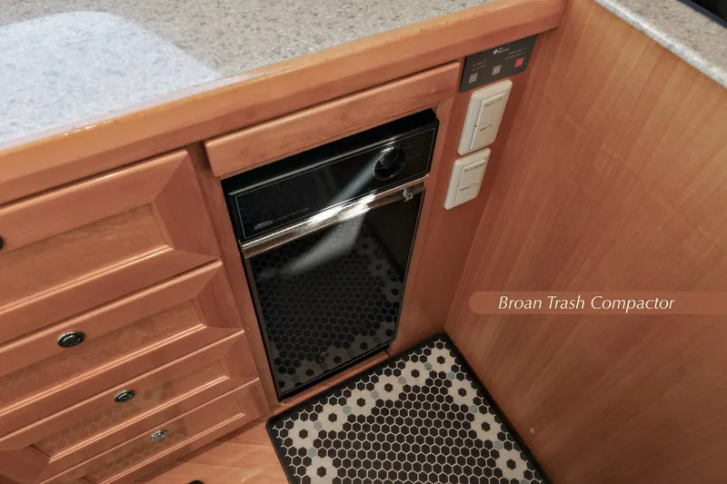 Slide: The Image of 2004 McKinna 57 Pilothouse kitchen with Broan trash compactor and wooden cabinetry. - 22