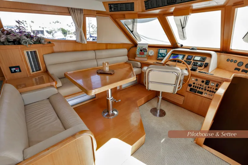 Slide: The Image of Luxurious 2004 McKinna 57 Pilothouse interior with helm, seating, and navigation equipment. - 26